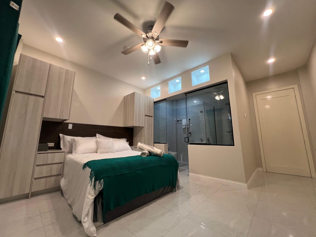 Halo Condo master bedroom with glass wall bench seat Trinidad condo
