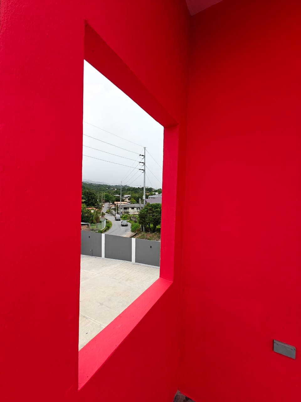 Halo Place apartment window opening to balcony view Trinidad